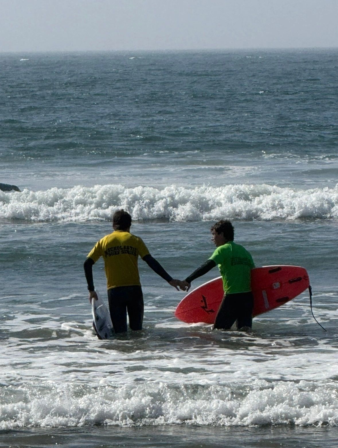 Surf instructor with child in the ocean